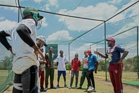  Former Kenya wicket-keeper, David Obuya (R) talks to young players at the Obuya Cricket Academy 