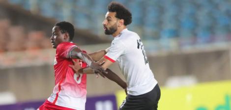 Kenyan defender Eric Ouma (left) playing against Liverpool's Mohamed Salah during a past AFCON match.