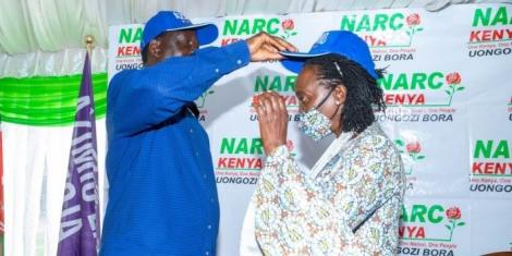 Raila Odinga (left) dawns Martha Karua with an Azimio la Umoja -branded cap at Serena Hotel, Nairobi on Wednesday, March 23, 2022..jpg