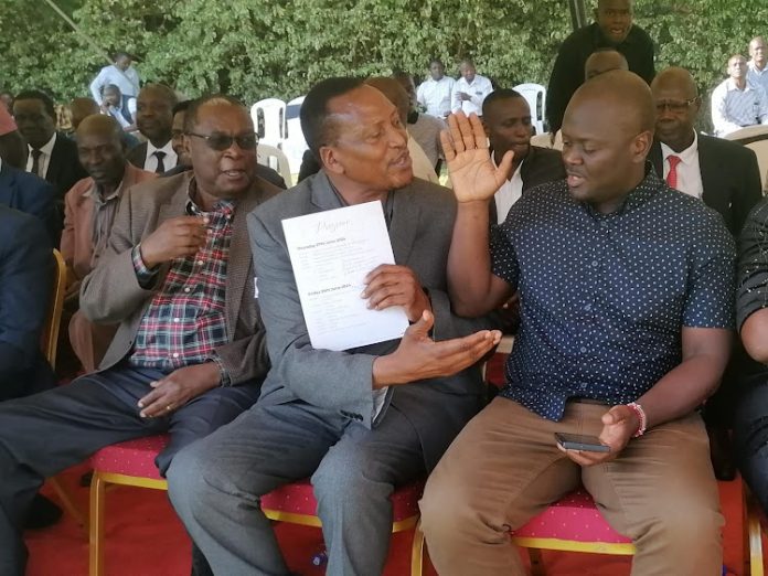 Kisii Senator Richard Onyonka (Centre) confering with Kitutu Chache South MP Anthony Kibagendi (right) during the burial of business mogul Peter Bogonko at Nyakoe in Kisii on Friday June 28, 2024