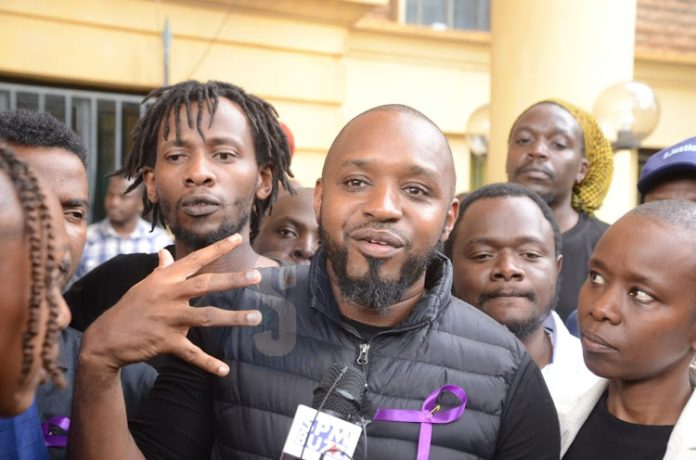 Activist Boniface Mwangi addresses journalists outside Milimani Law Courts after the DPP found no charges against him and four others on June 19, 2024.