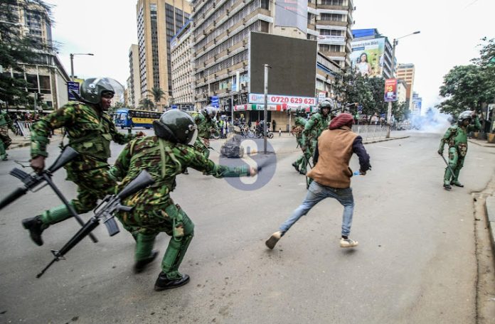 Anti-government protester engages police officers in running battles along Nairobi's Moi Avenue on July 16, 2024.